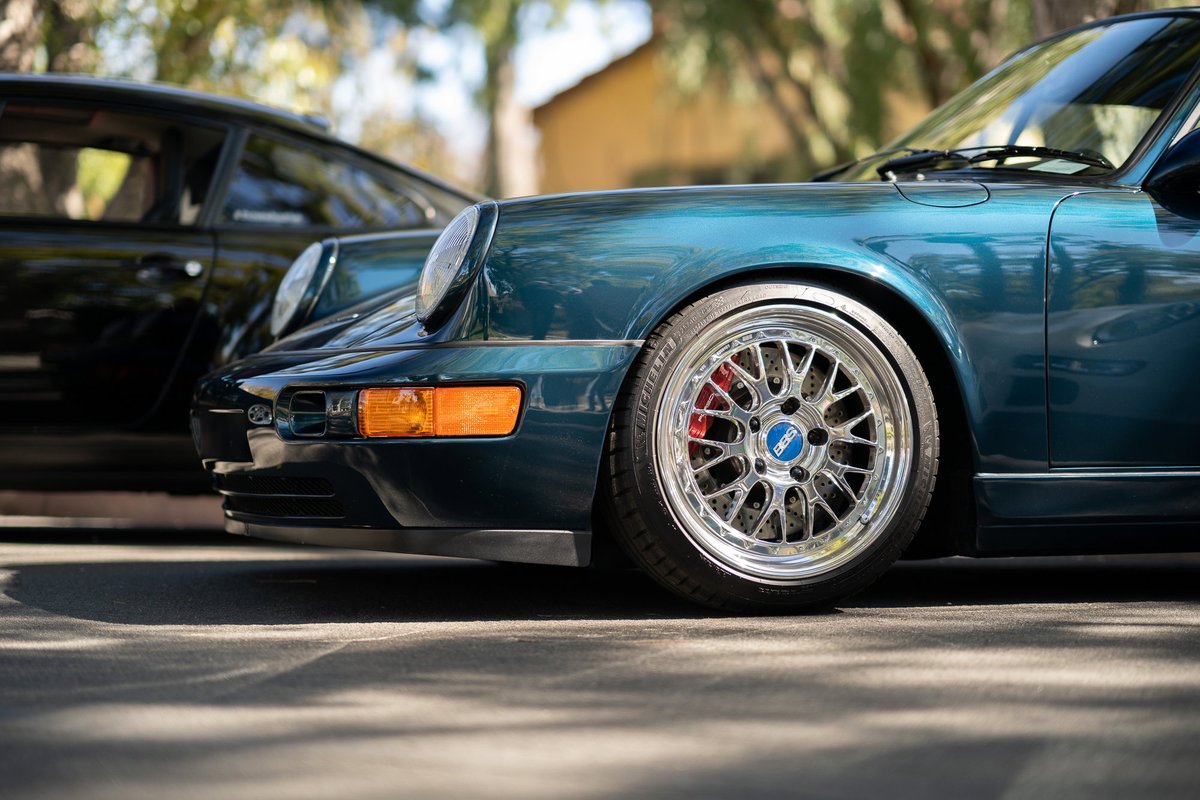 Teal 964 Porsche 911 with BBS wheels and red brake calipers.