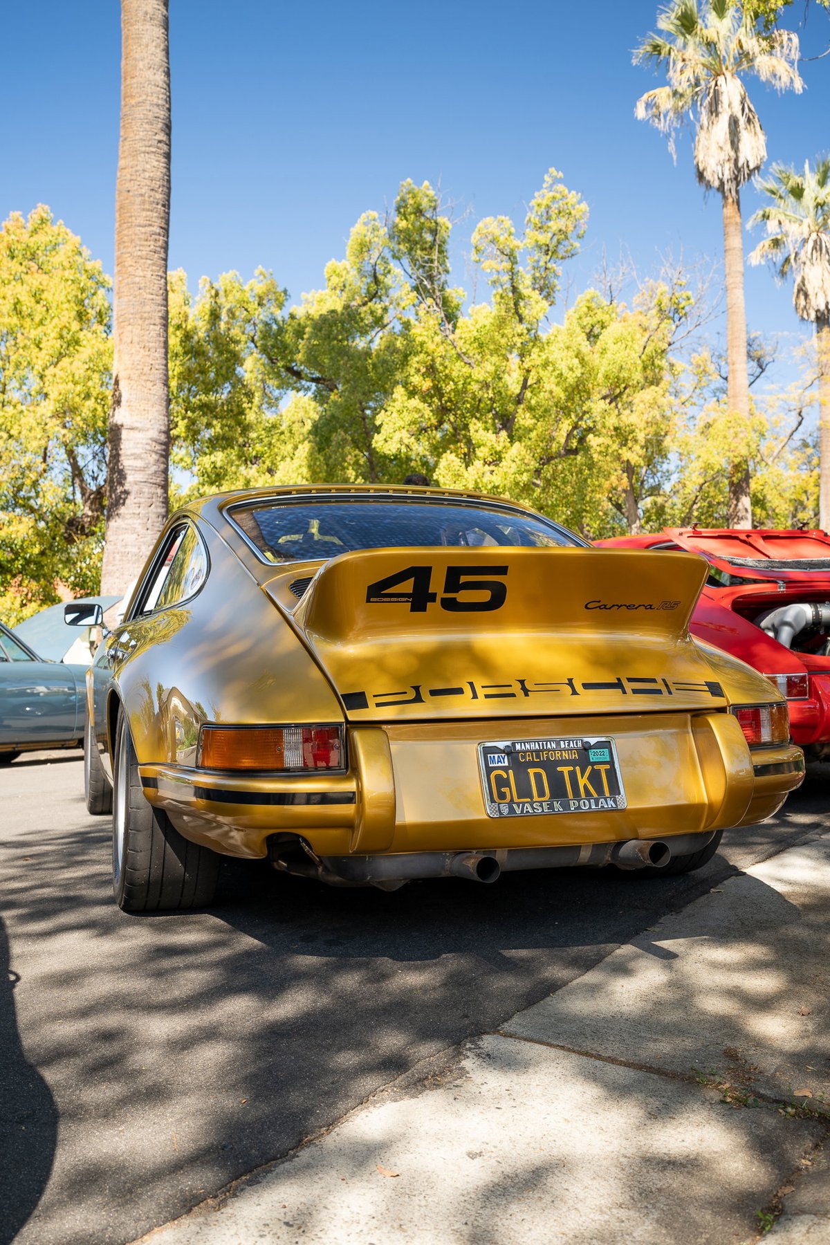 Gold 1970s Porsche Carrera RS 2.7 with #45 livery and ducktail spoiler.