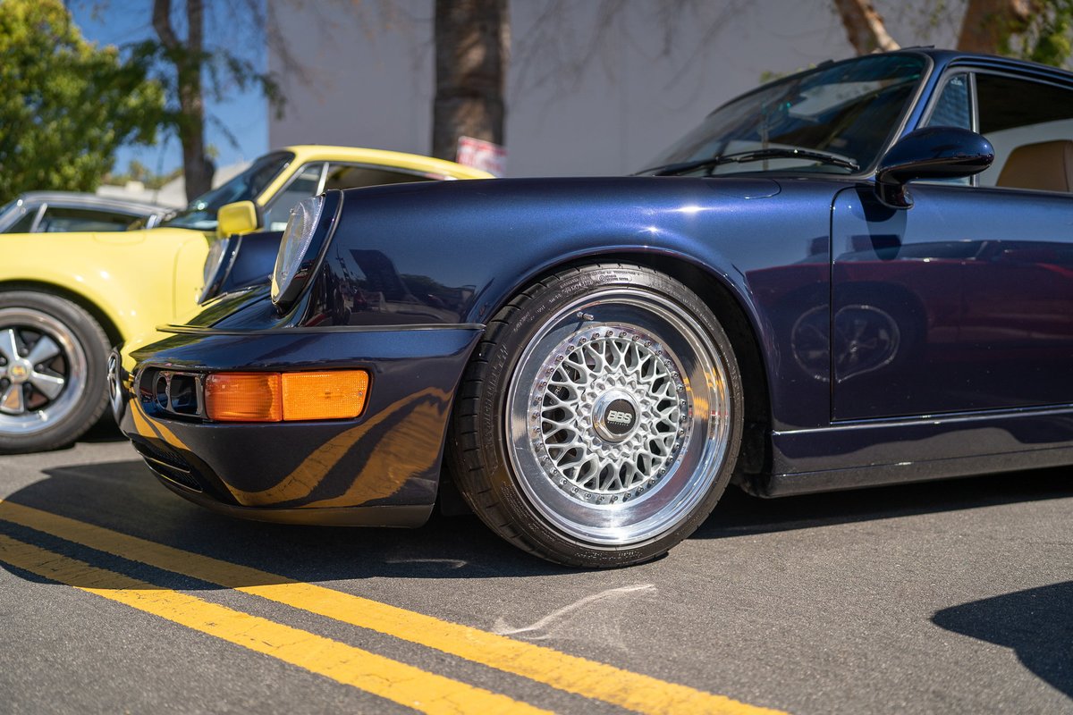 Front quarter view of a navy blue Porsche 911 with BBS mesh rims.