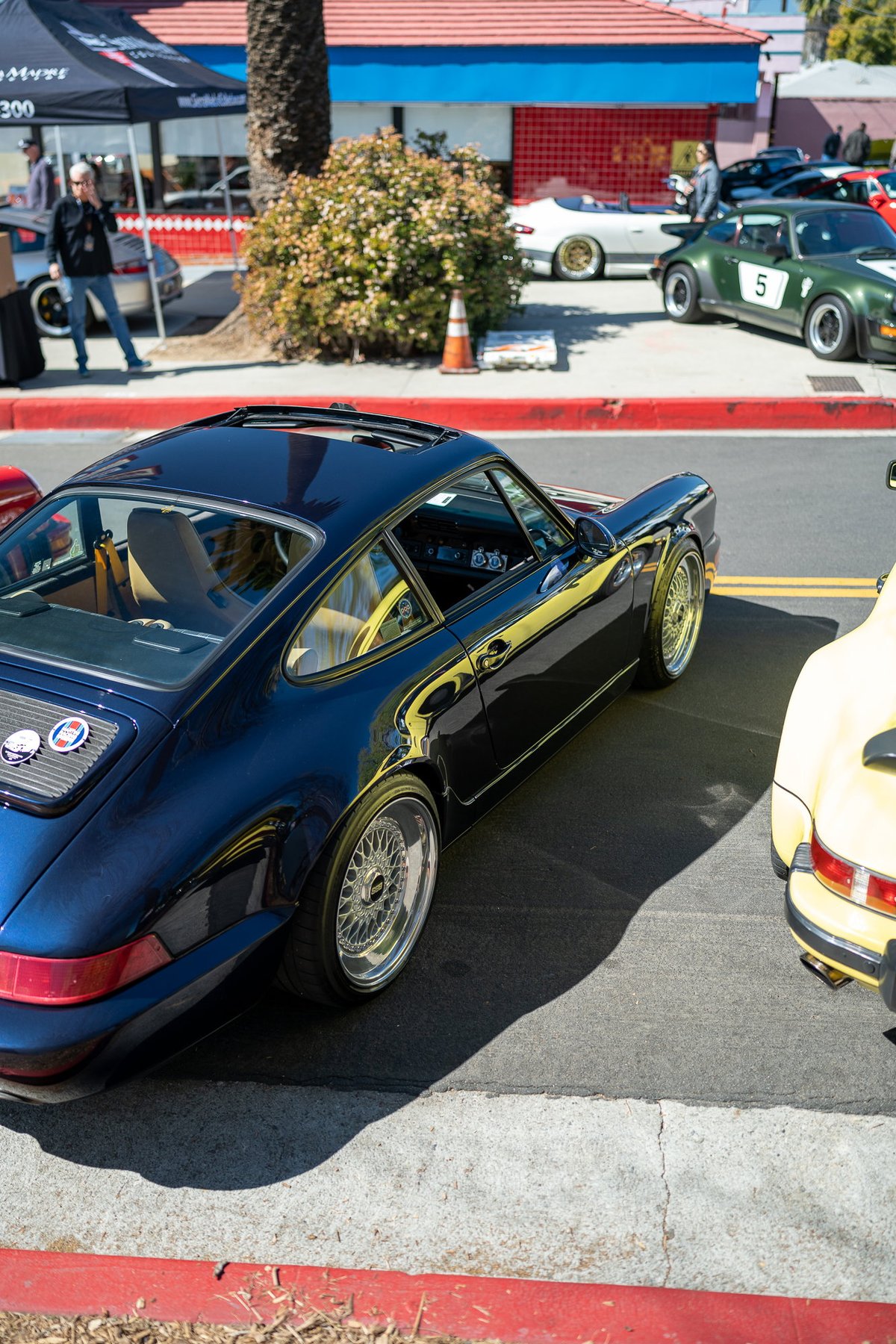 1973 Porsche 911 Carrera RS Targa in dark blue with BBS rims and yellow trim.