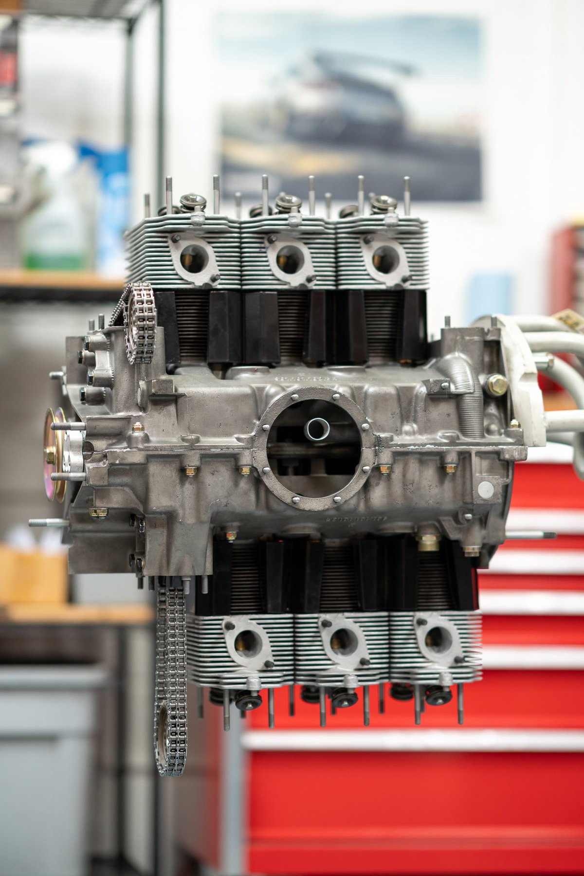 Porsche 911 engine, air-cooled flat-six, with cooling fins and timing chain.