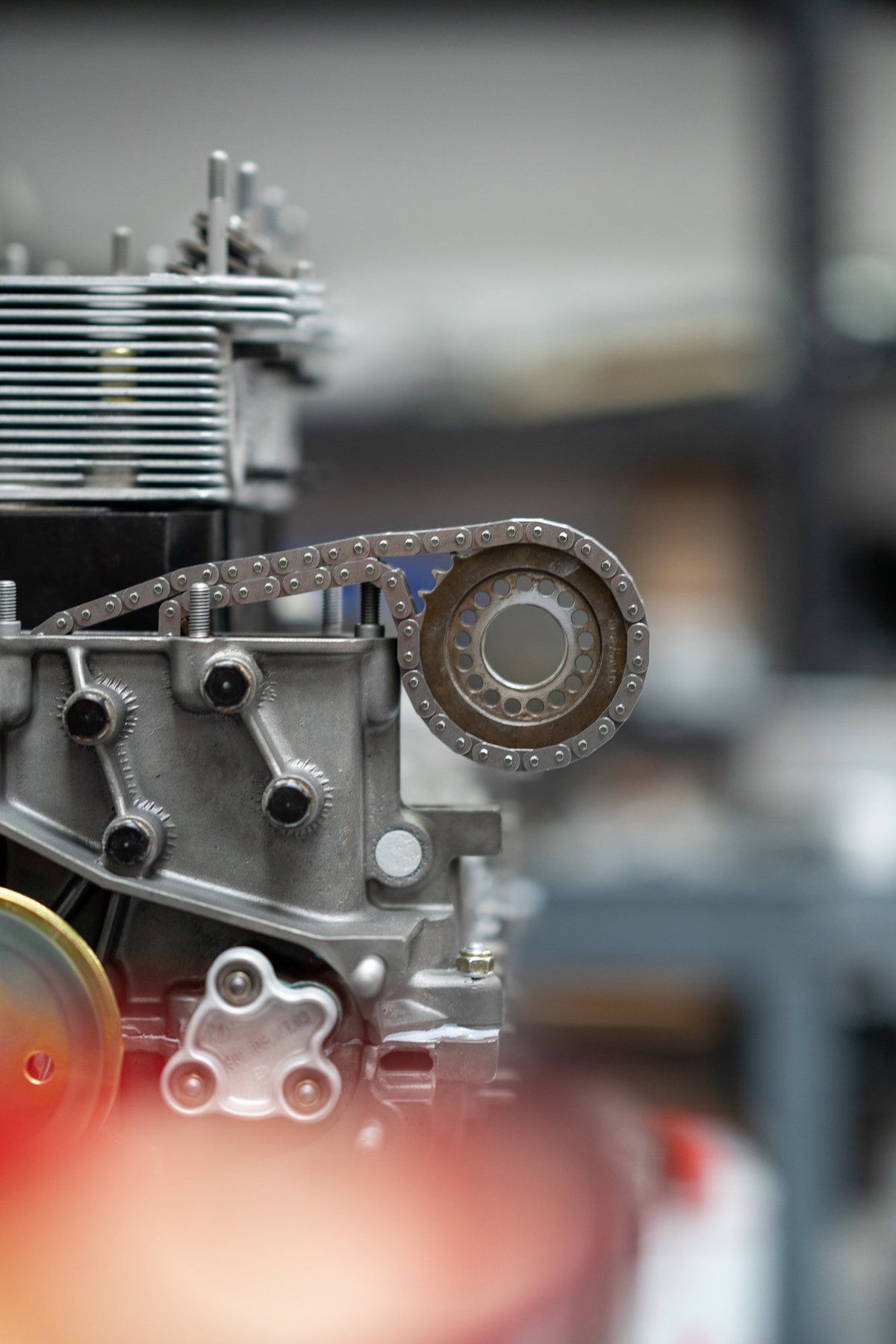 Close-up on timing chain and sprocket of a classic Porsche 911 engine.