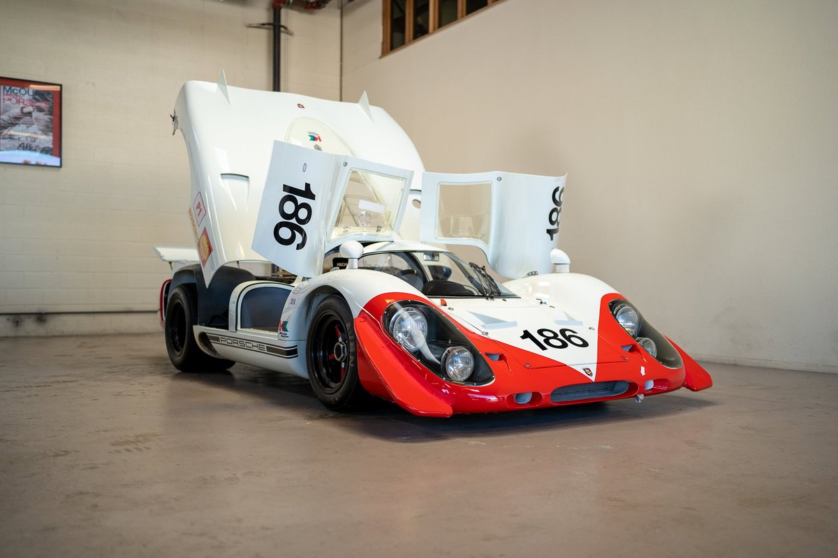 Vintage Porsche 917K race car, white with red accents and "186" livery.