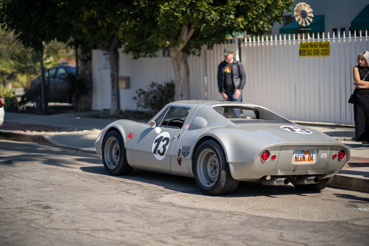 Silver 1966 Porsche 906 with racing livery and #13 on the rear.