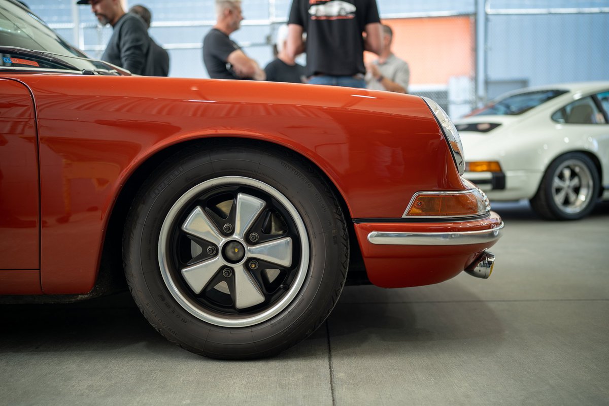 Close up of a red Porsche 911 with Fuchs rims.