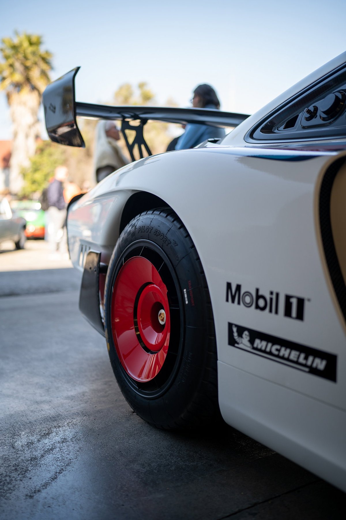 White Porsche 935 with red center-lock rims, Mobil 1 & Michelin livery.