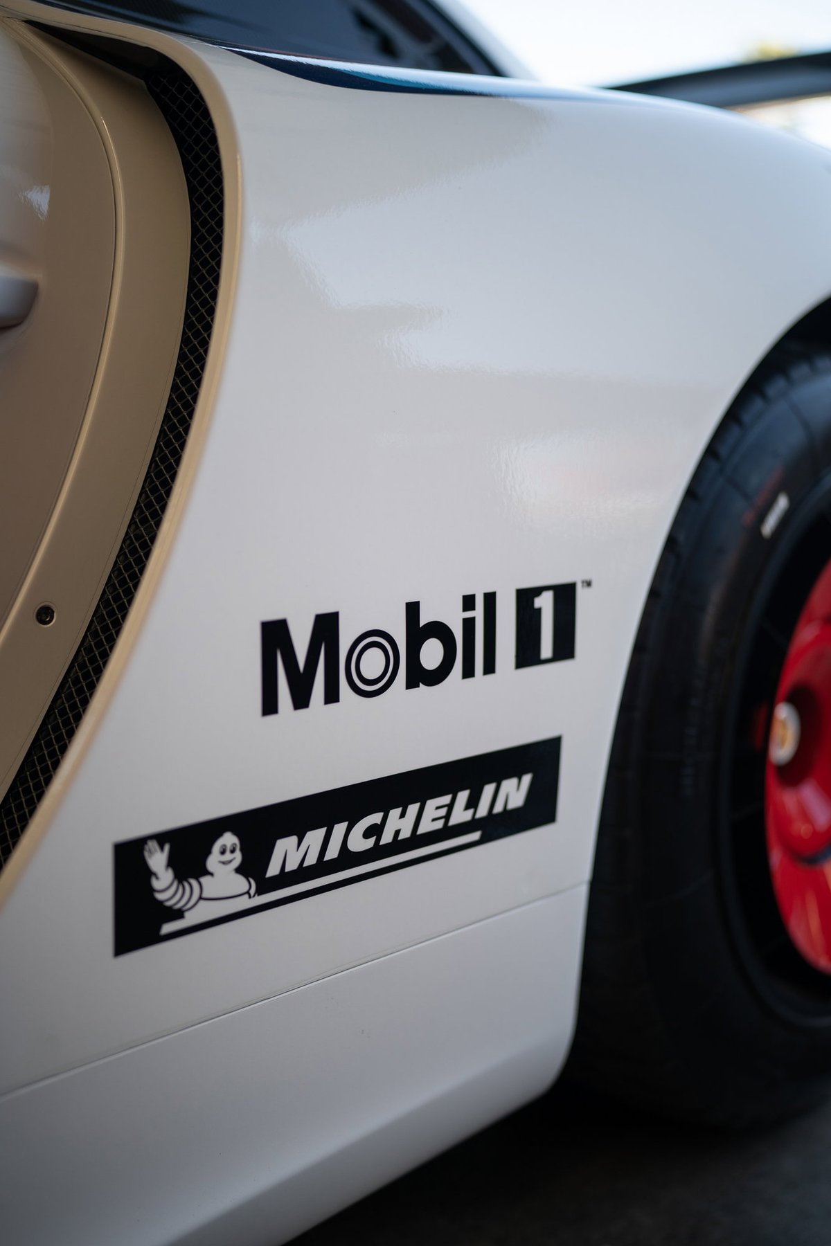 White Porsche 911 with Mobil 1 and Michelin livery on the side panel.