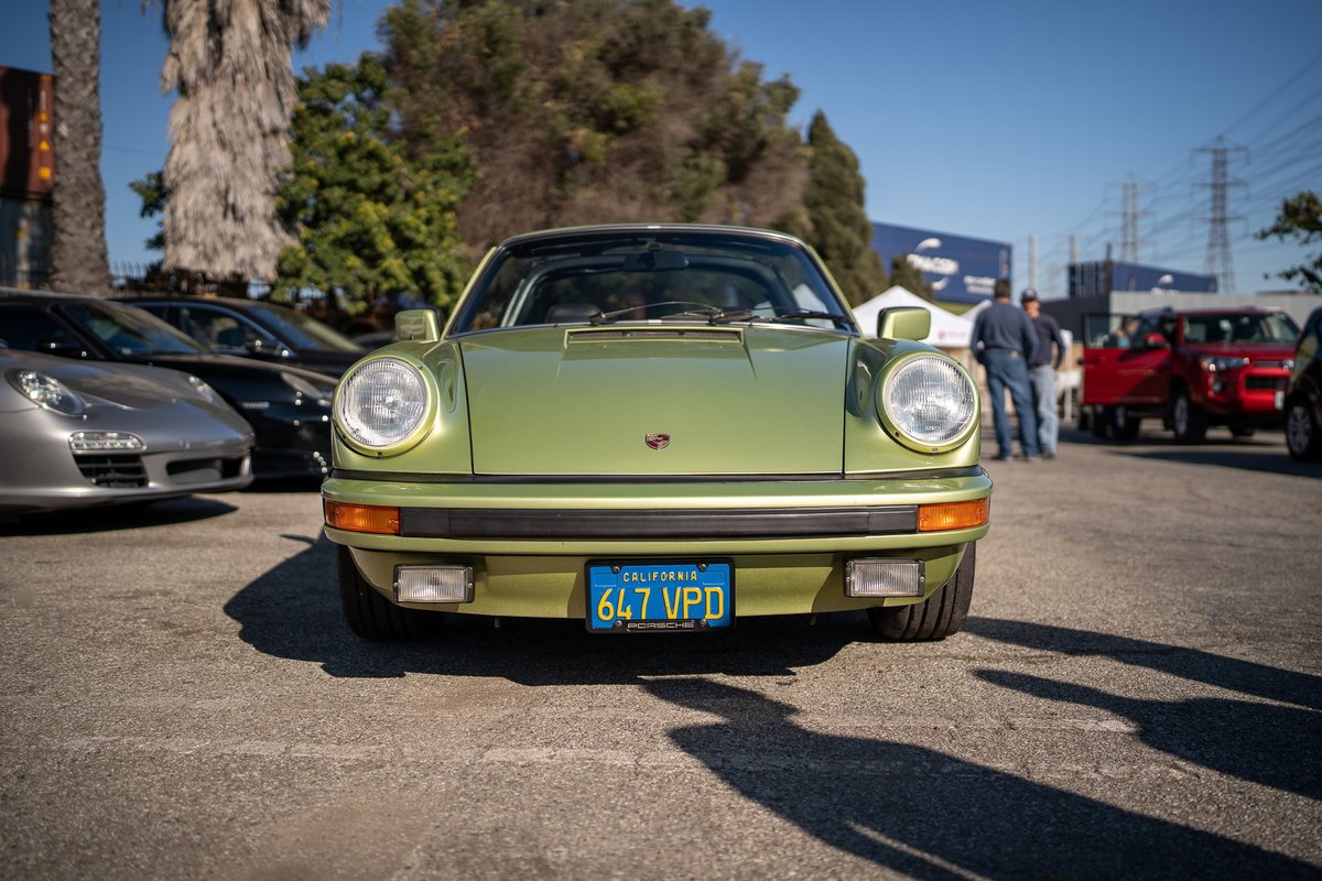 Green Porsche 911 with California plates, parked at the Lit Show LA.