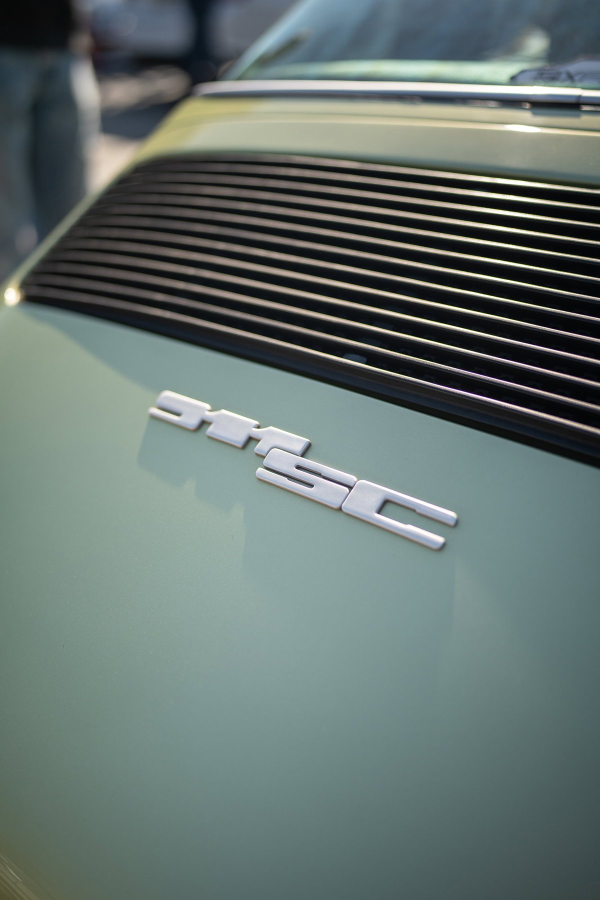 Porsche 911 SC (1978-1983) in pale green with black engine lid grille.