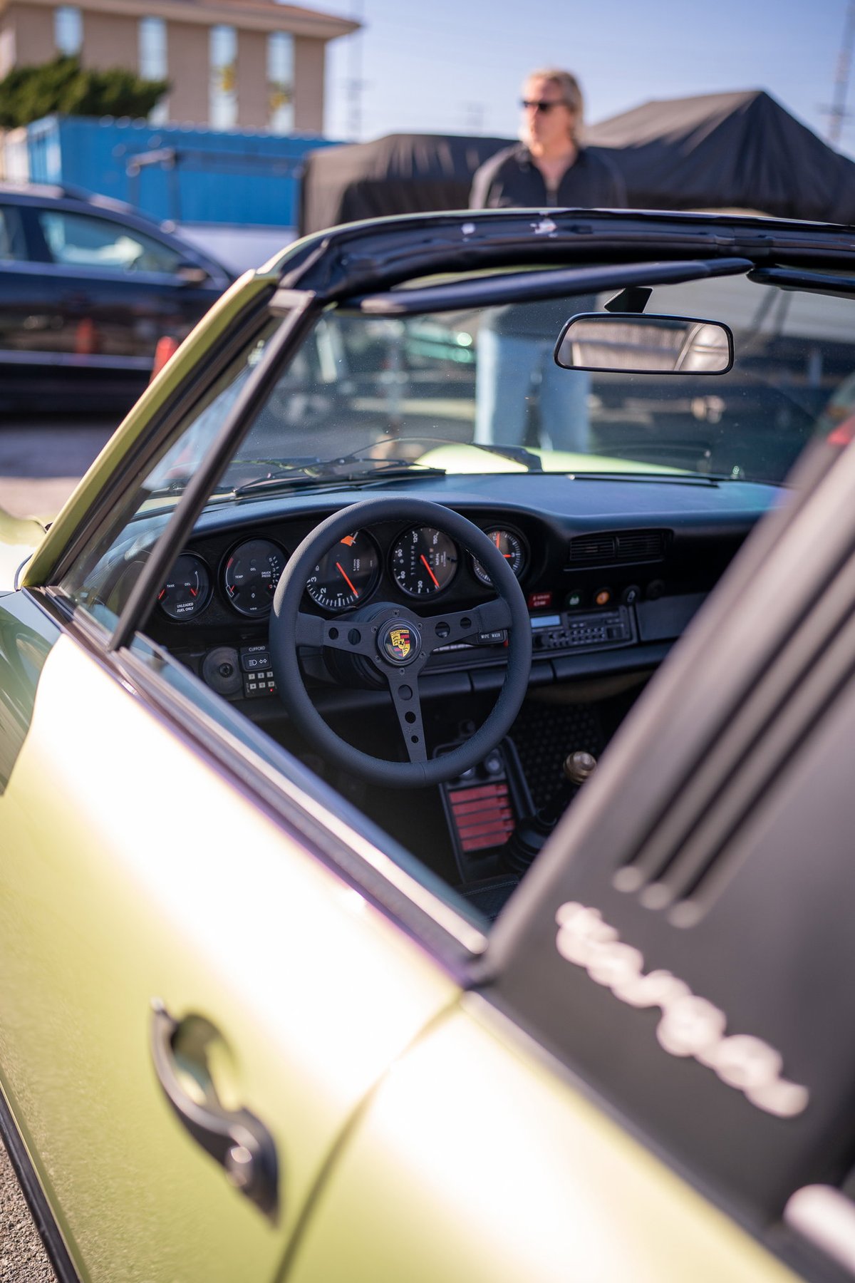 Porsche 911 Targa interior. Light yellow paint, black steering wheel, classic gauges.