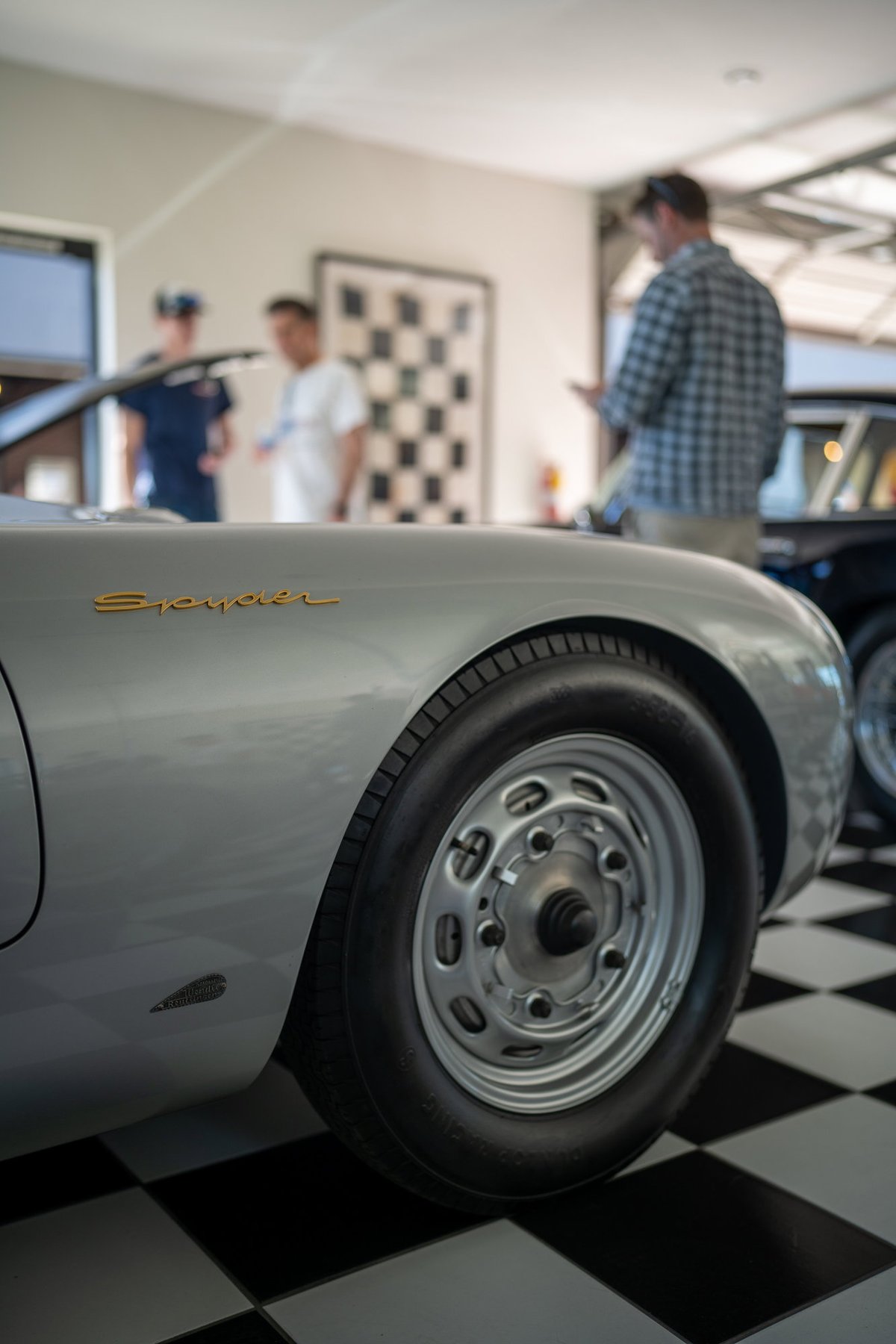 Silver Porsche 550 Spyder with gold badging on classic steel rims.