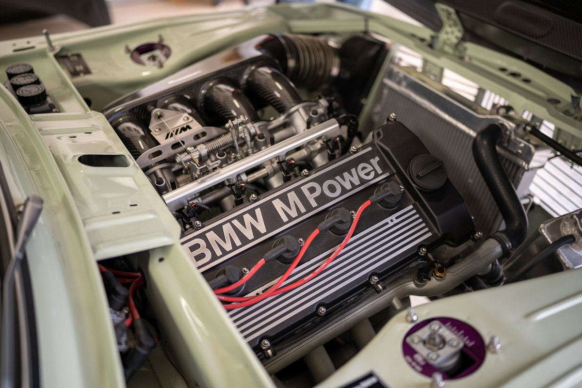 Custom BMW M Power engine, likely from a vintage E20 2002, in light green paint.