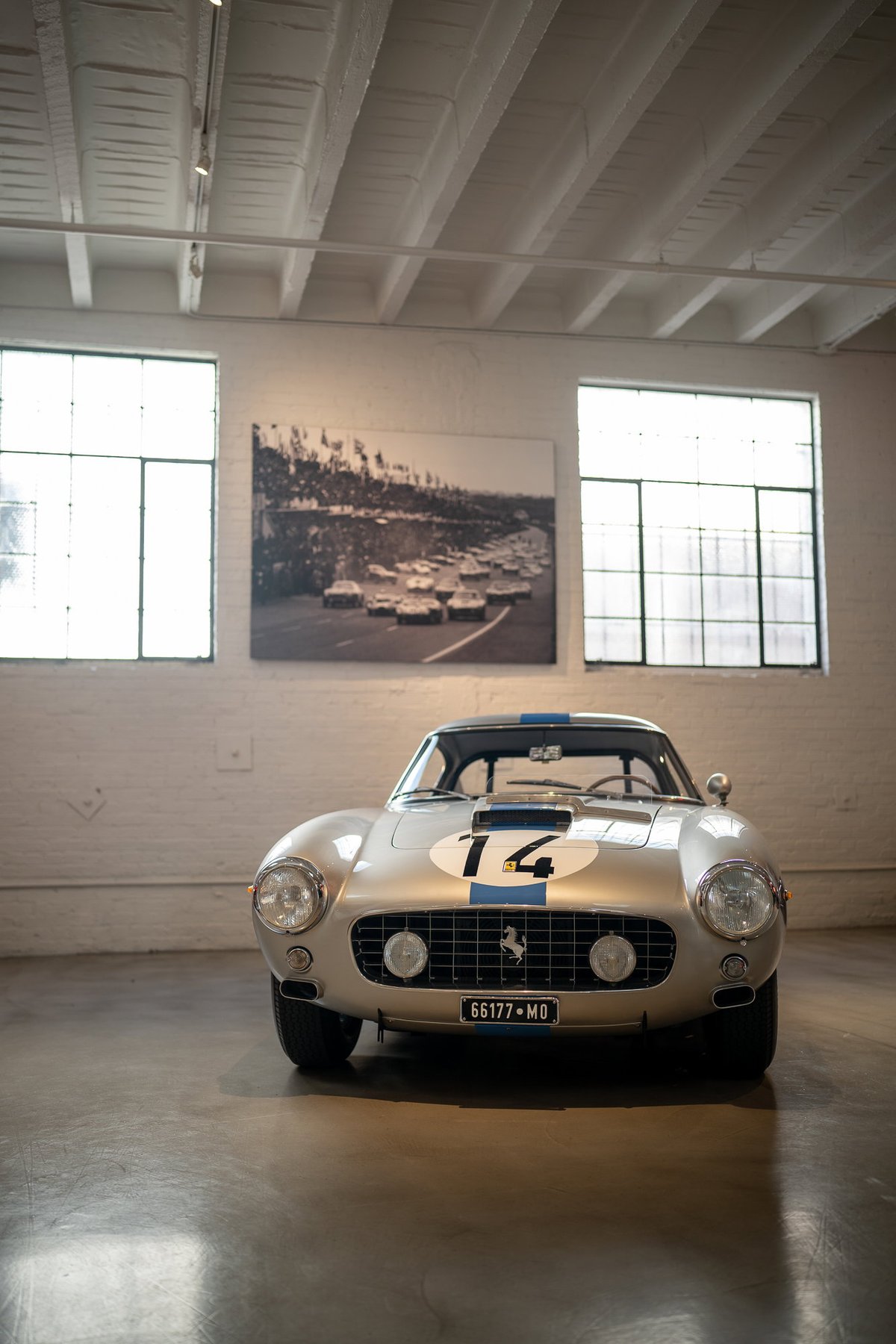 Silver Ferrari 250 GT Berlinetta with racing livery number "14" on hood.