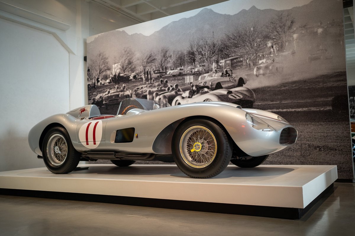 1950s Ferrari 500 TRC race car with iconic red and white racing livery and wire-spoke rims.