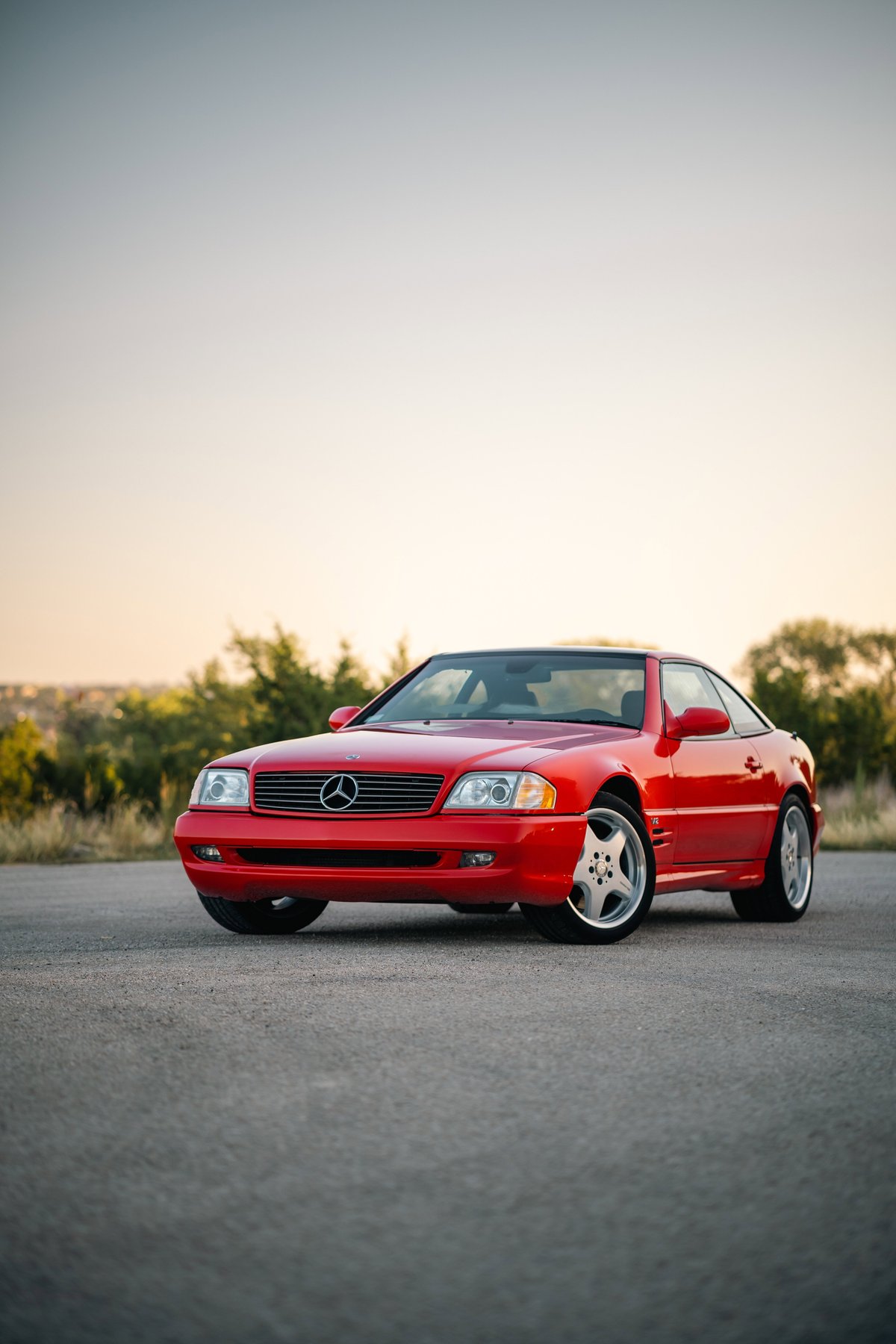 Red 2001 Mercedes-Benz SL600 with five-spoke alloy rims and chrome trim.