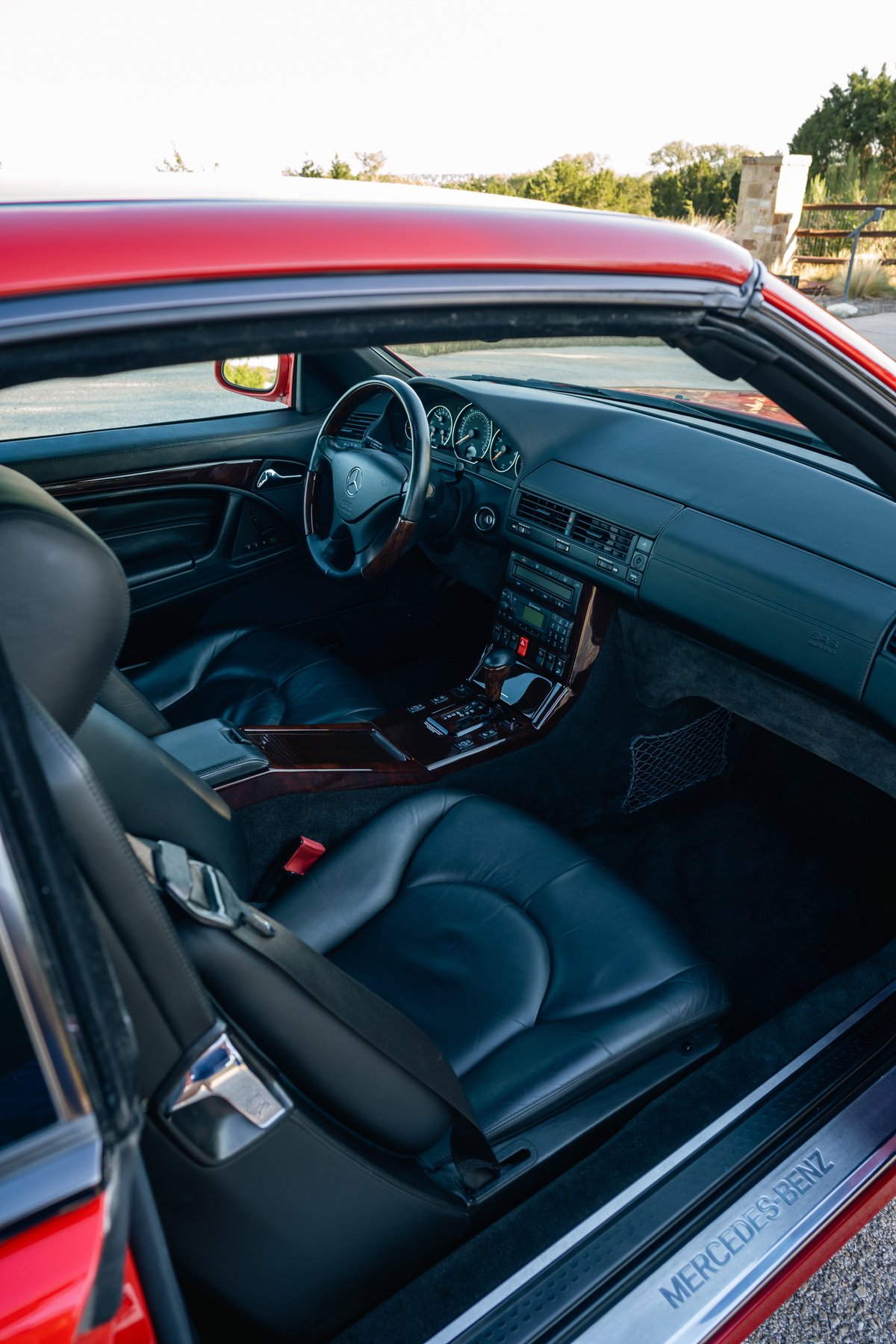 Red 2001 Mercedes-Benz SL600 interior with black leather seats and wood trim.