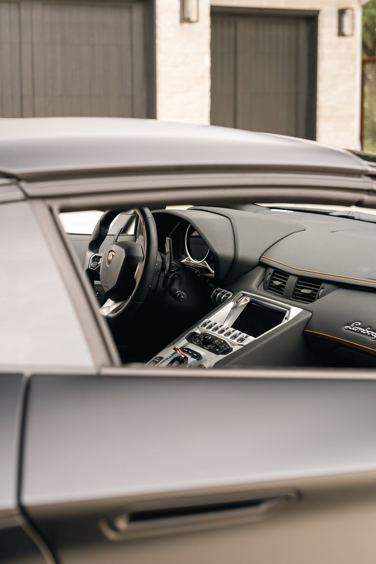 Lamborghini Aventador LP700-4 interior, showing sport seats, digital dash, and center console.
