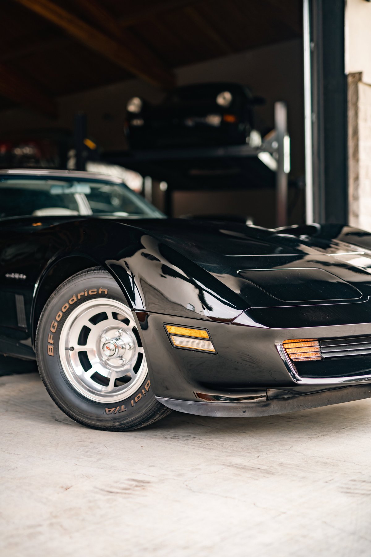 A black 1982 Chevrolet Corvette Stingray with polished alloy rims and BFGoodrich tires.