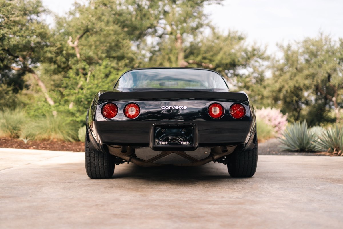 Rear view of a black 1982 Chevrolet Corvette Stingray.