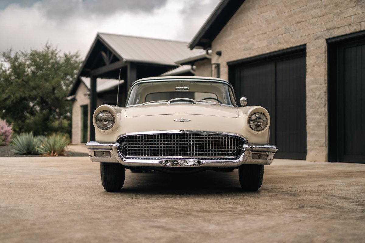 Front view of a Colonial White 1957 Ford Thunderbird with chrome grille and trim.
