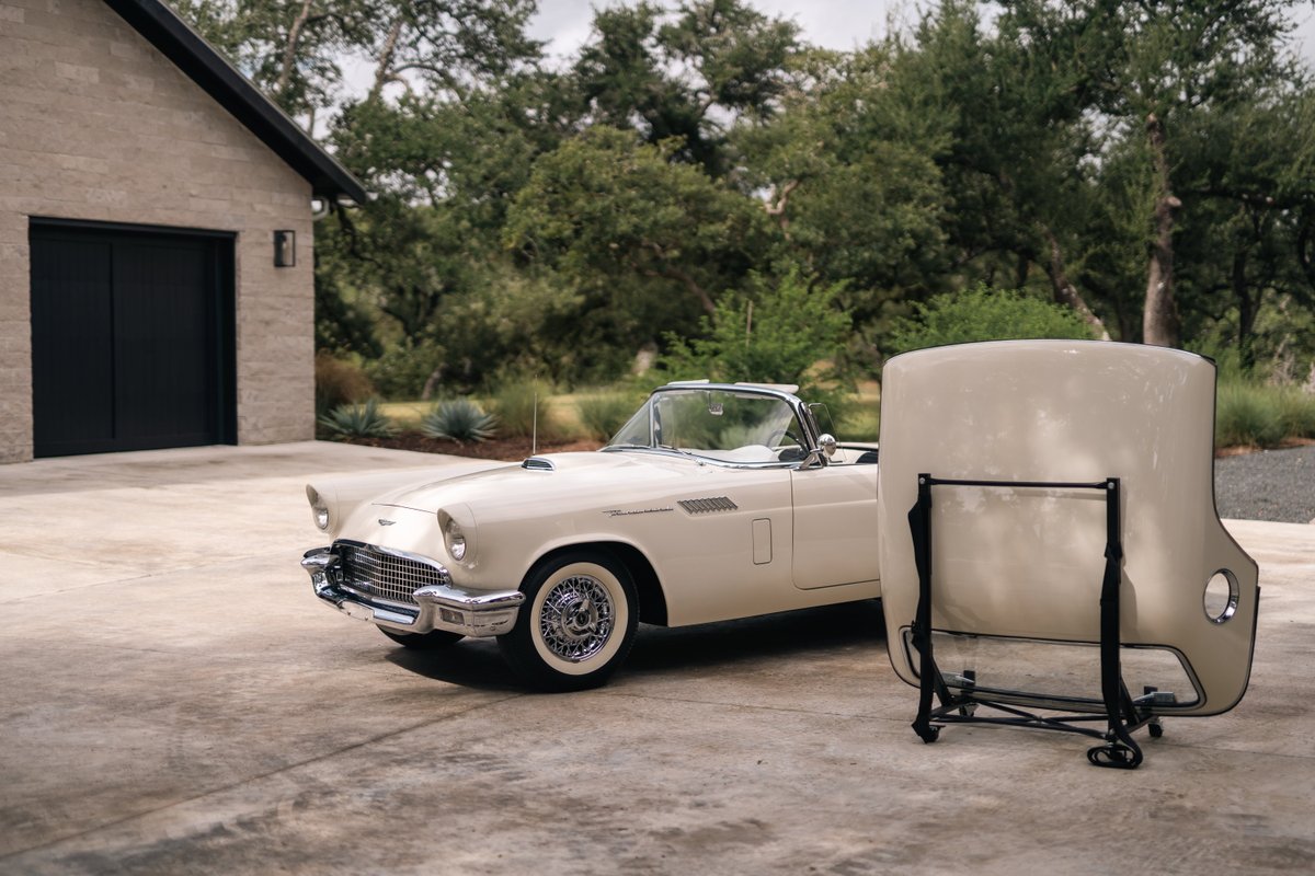 1957 Ford Thunderbird convertible in Colonial White, with wire wheel rims and chrome trim.