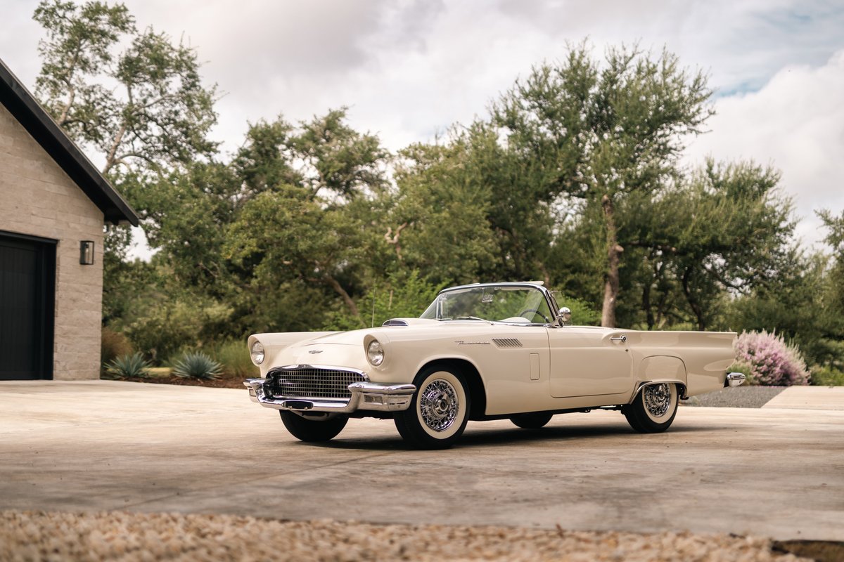 1957 Ford Thunderbird convertible, colonial white paint, chrome trim, wire-spoke rims.