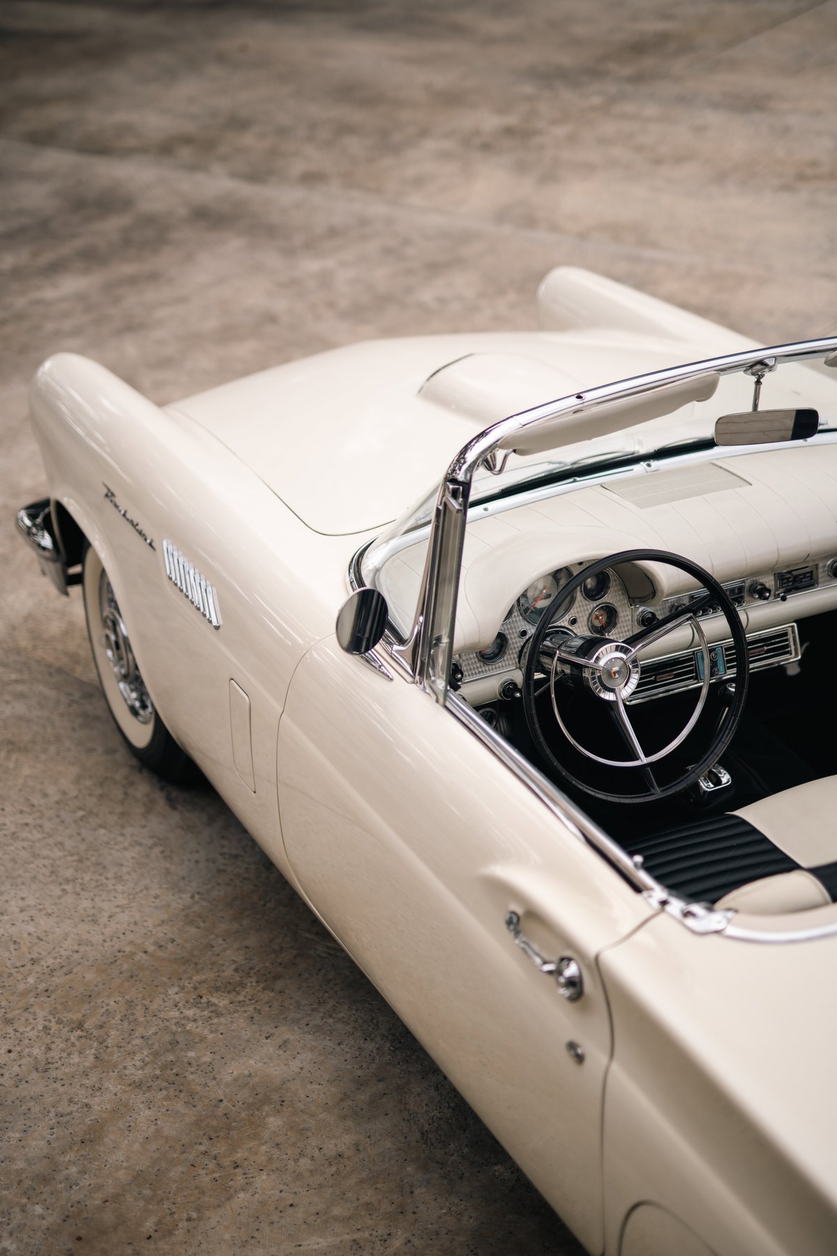 1957 Ford Thunderbird convertible in Colonial White. Close-up on interior and side body panel.