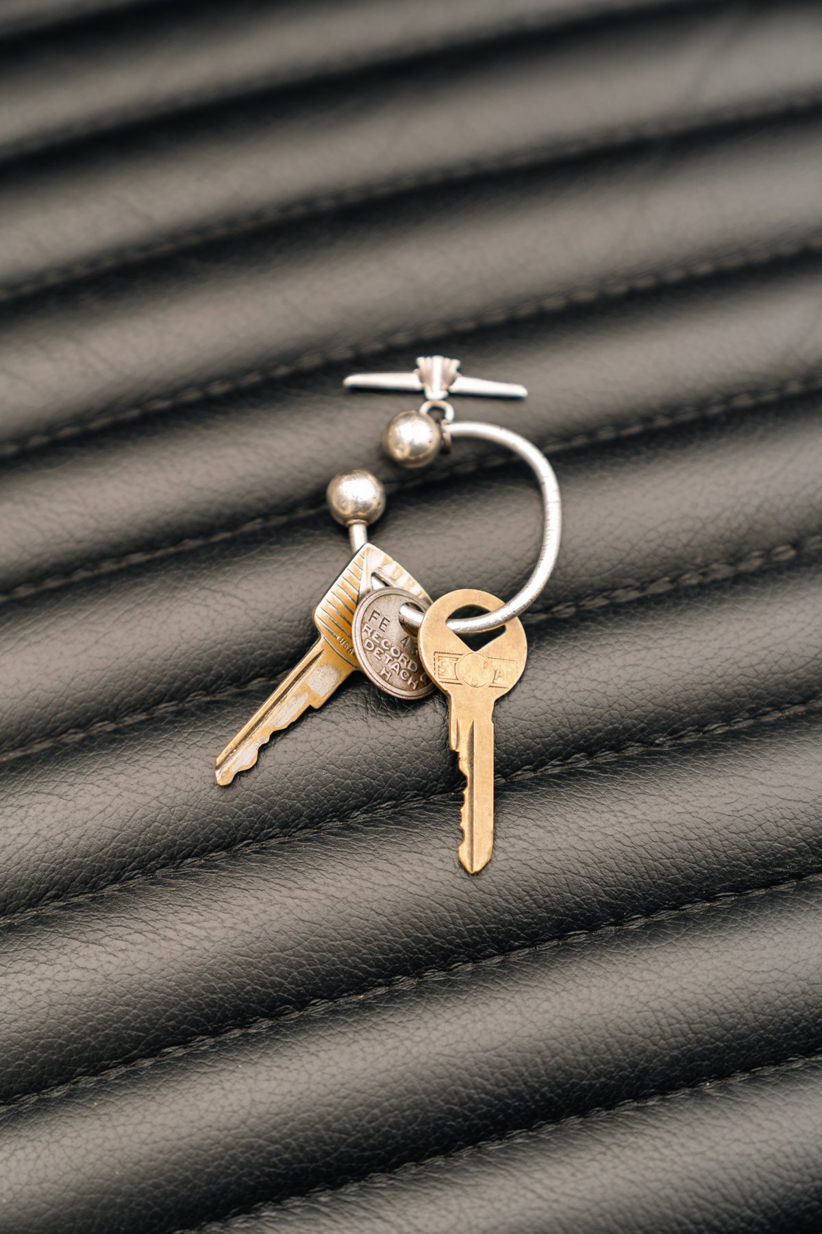 Vintage 1957 Ford Thunderbird keys on quilted leather.