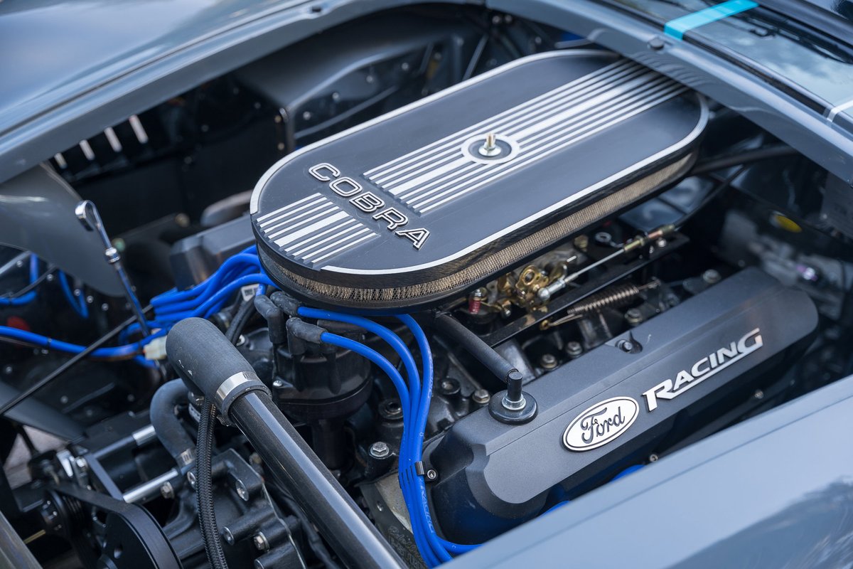 1965 Backdraft Cobra with a Ford Racing engine, featuring a Cobra air cleaner and blue spark plug wires.