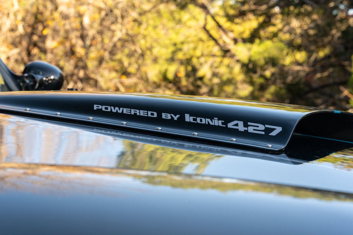 Black 1965 Backdraft Cobra hood with "Powered by Iconic 427" text.