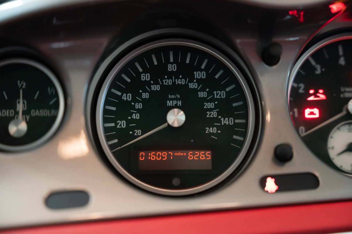 Dashboard of a silver 2002 BMW Z8 showing odometer reading 16,097 miles.