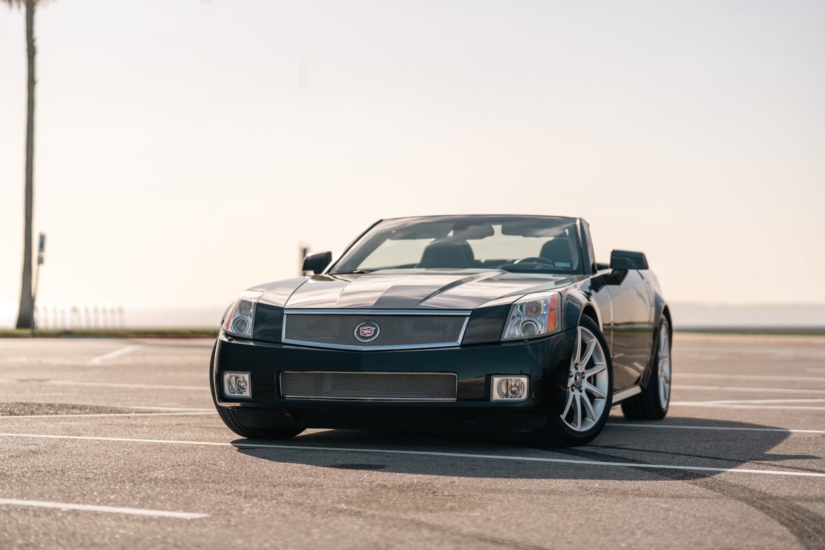 2006 Cadillac XLR-V convertible in Black Raven, featuring polished rims and chrome trim.