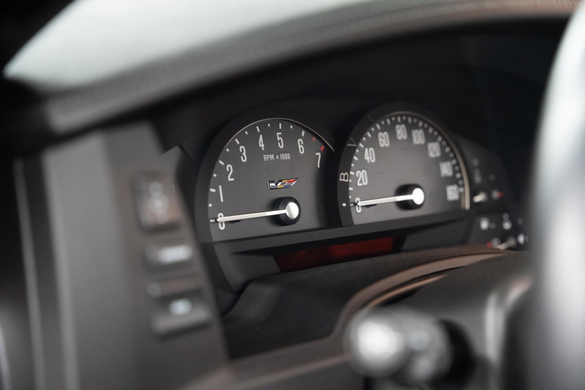 Black Raven 2006 Cadillac XLR-V dashboard with RPM and speed gauges.