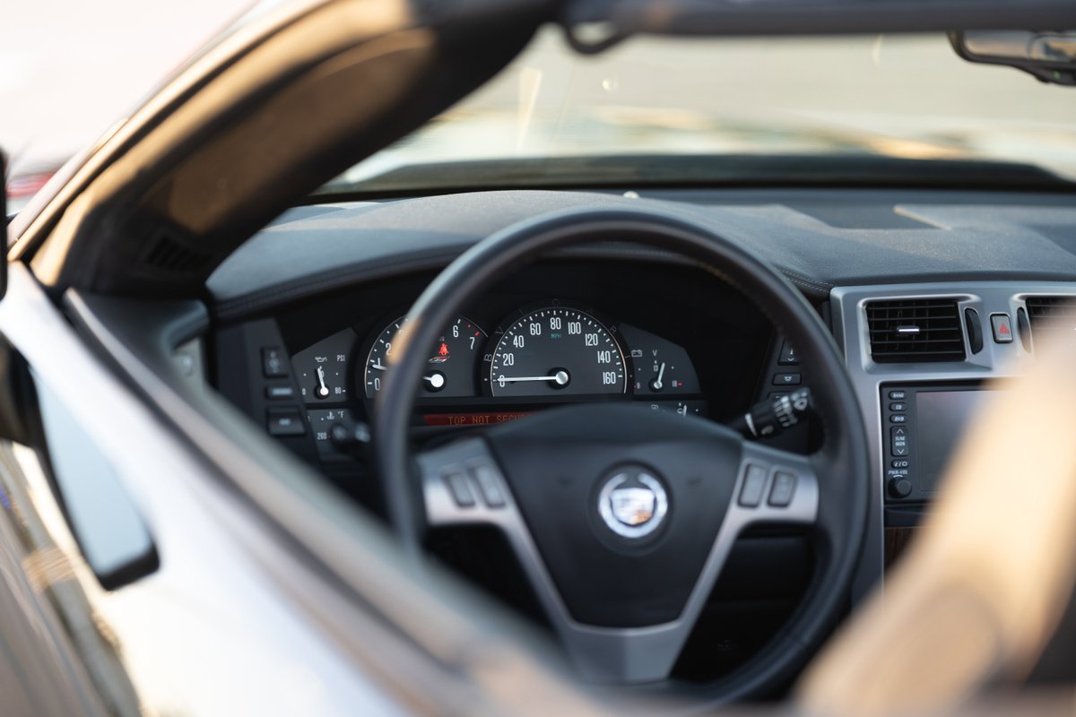 2006 Cadillac XLR-V convertible dashboard, showing the steering wheel, instrument cluster, and infotainment system.