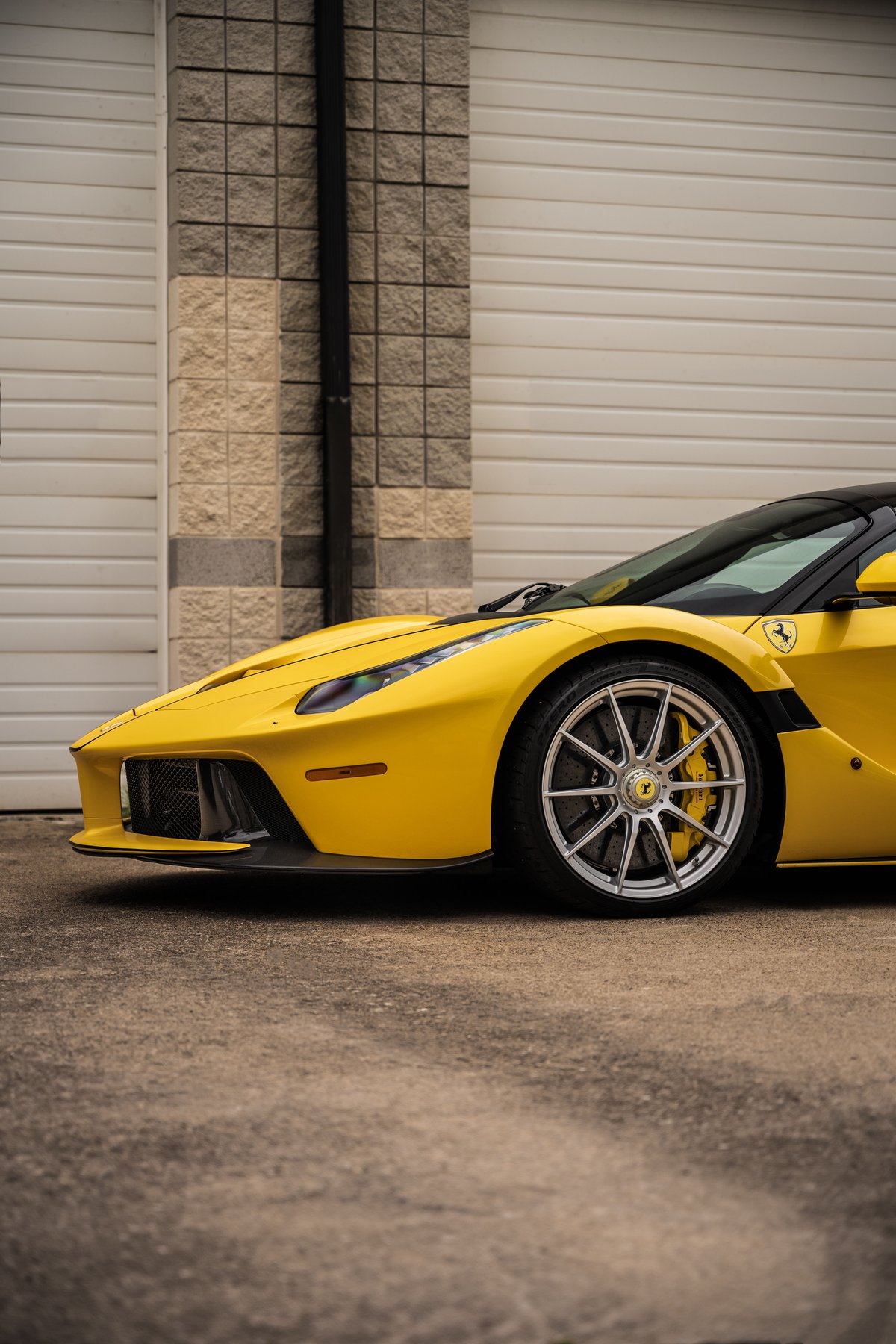 Yellow Ferrari LaFerrari Aperta with silver rims, yellow calipers, and black trim.