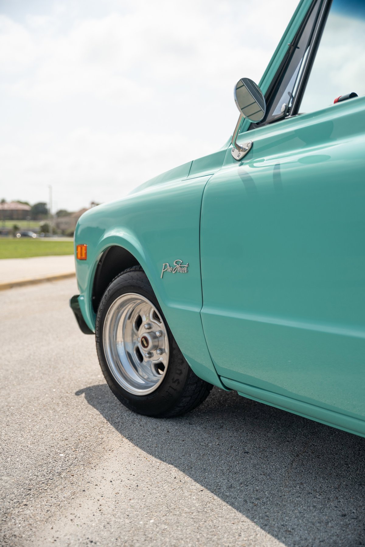 Teal 1968 Chevrolet C10 Pro-Street pickup with chrome rims and "Pro-Street" badging.