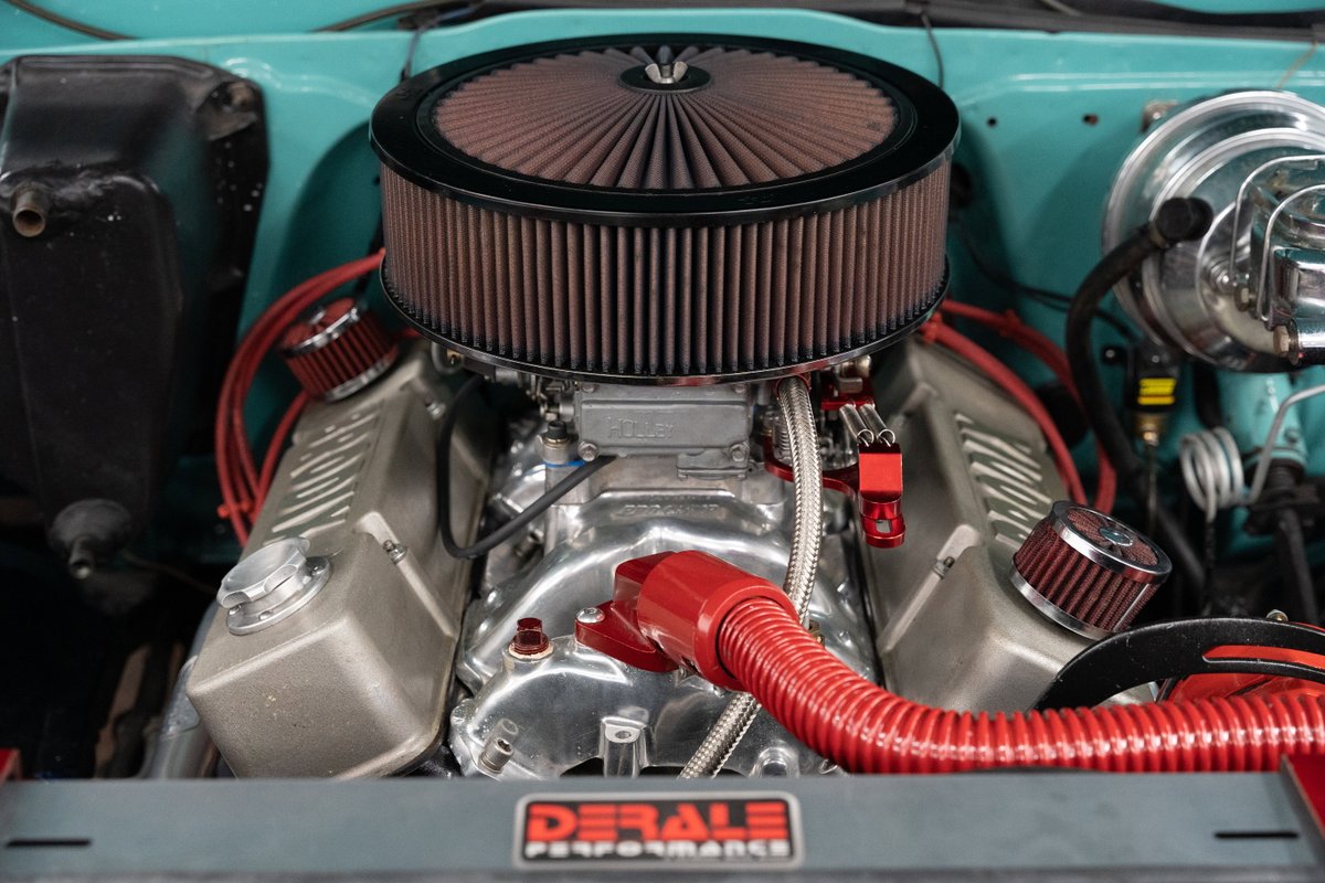Close-up of a 1968 Chevrolet C10's engine bay, featuring a large chrome air cleaner & aluminum valve covers.