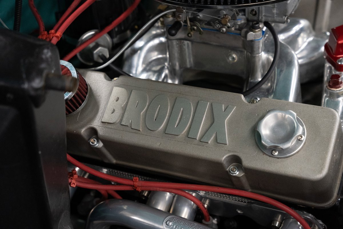 Close-up of a 1968 Chevrolet C10 engine with a BroDixi valve cover and chrome intake.