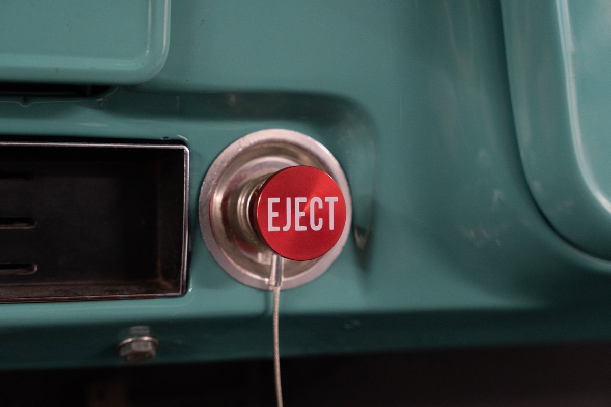 Red "EJECT" button with chrome trim on teal 1968 Chevrolet C10 Pro-Street dash.