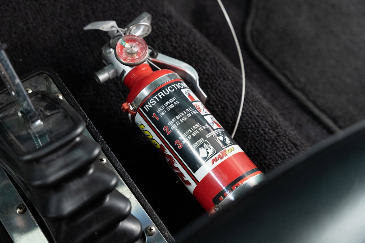 Red fire extinguisher inside a 1968 Chevrolet C10 Pro-Street.