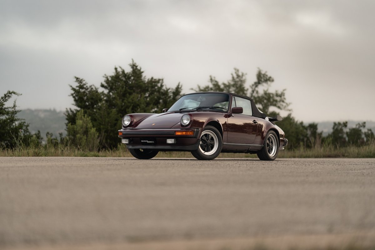 Ruby Red Metallic 1983 Porsche 911 SC Cabriolet on alloy rims.