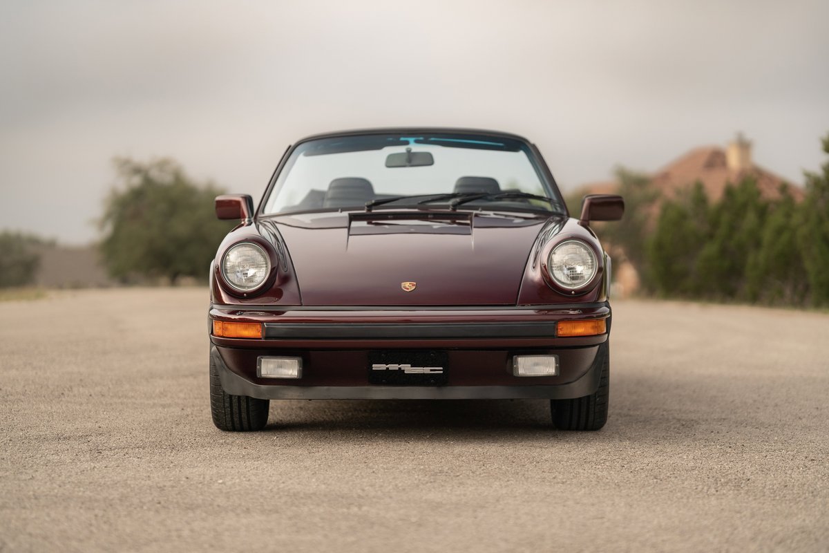 Ruby red metallic 1983 Porsche 911SC Cabriolet front view.