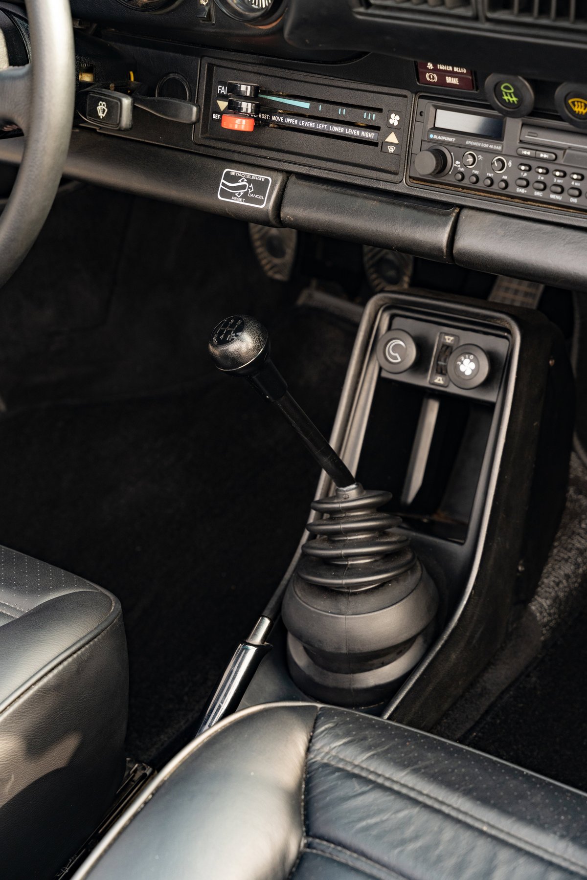 1983 Porsche 911 SC Cabriolet interior: manual shifter, leather seats, climate controls.