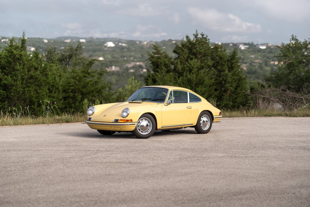 Champagne Yellow 1969 Porsche 912 coupe with chrome trim and polished rims.