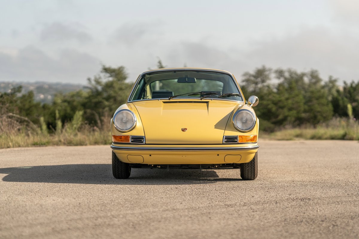 Front view of a yellow 1969 Porsche 912 coupe.