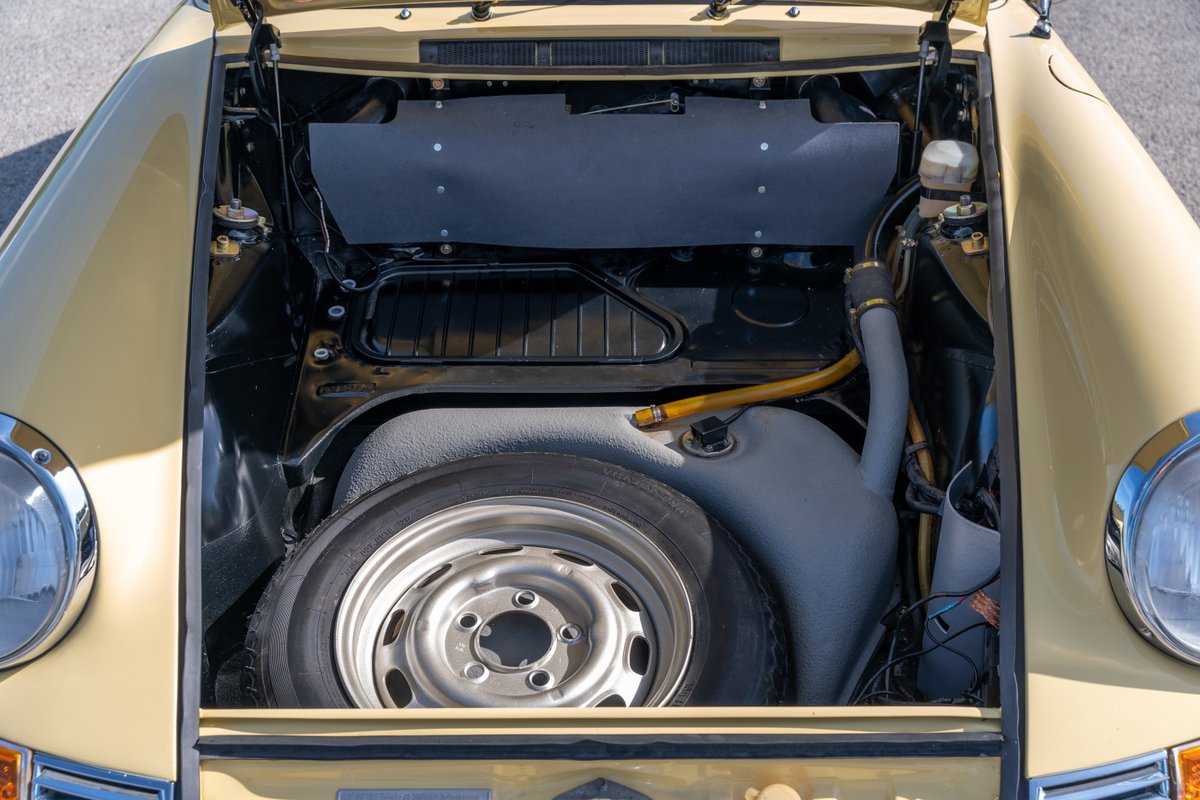 Champagne Yellow 1969 Porsche 912 coupe front trunk with spare tire and fuel tank.