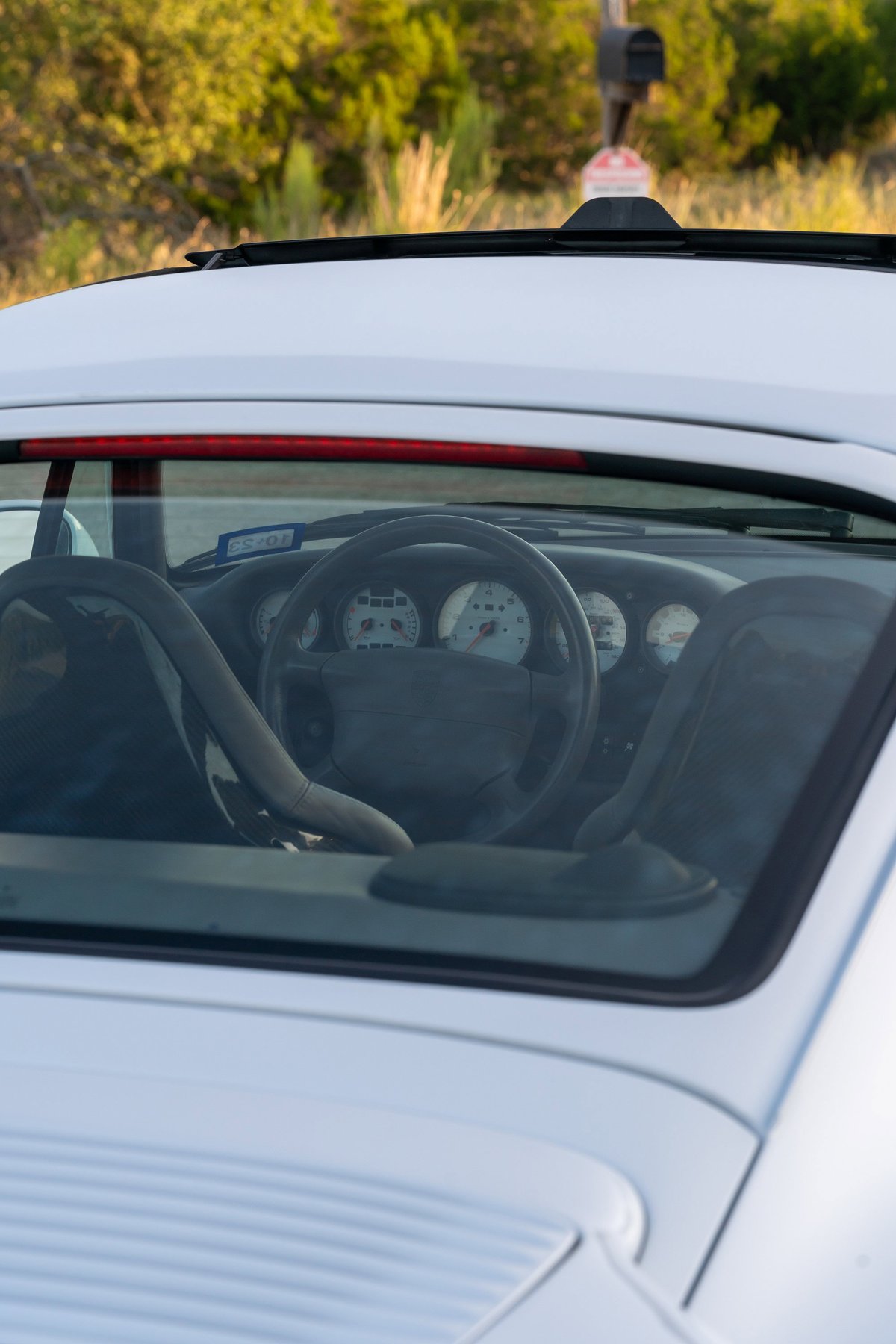 White 1997 Porsche 911 993 C4S interior, showing dashboard gauges & steering wheel.