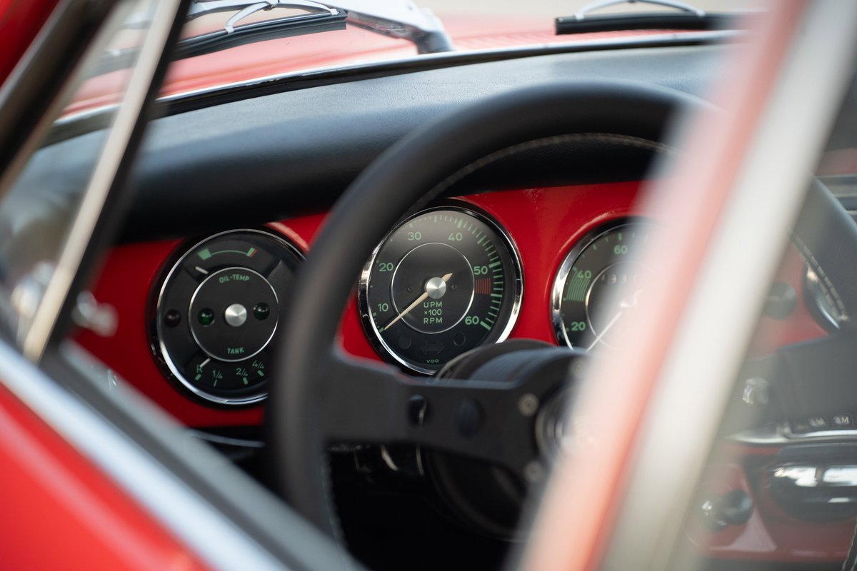1965 Porsche 356C interior: red dash, black steering wheel, three classic gauges.