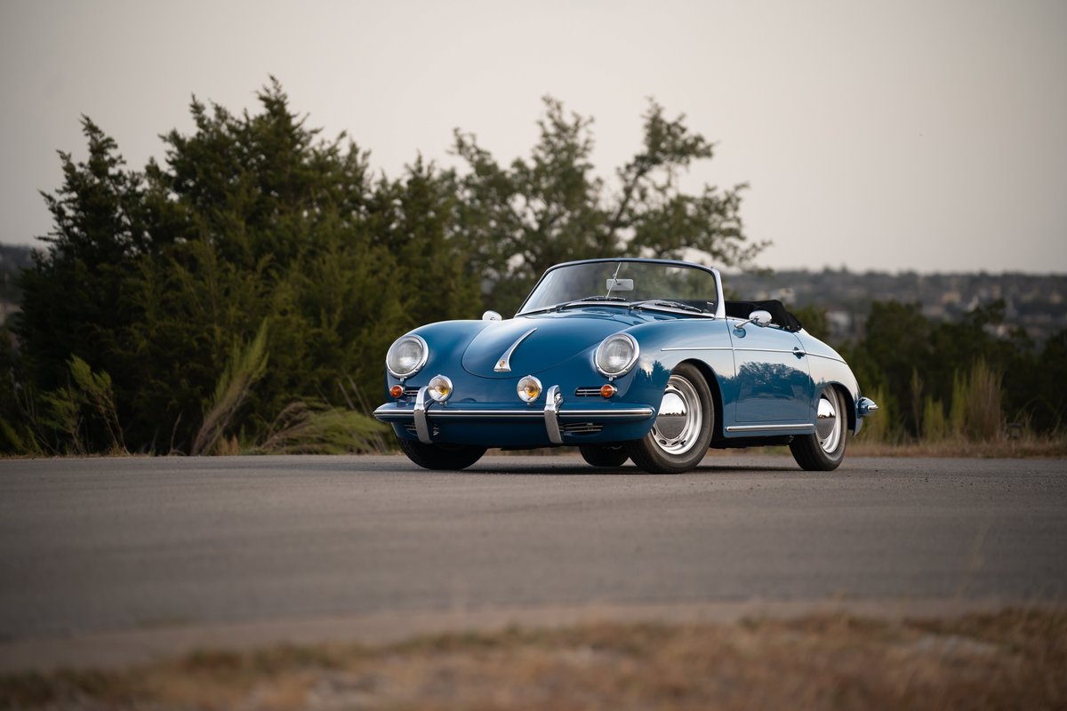 Royal blue 1960 Porsche 356B Roadster with chrome trim and hubcaps.