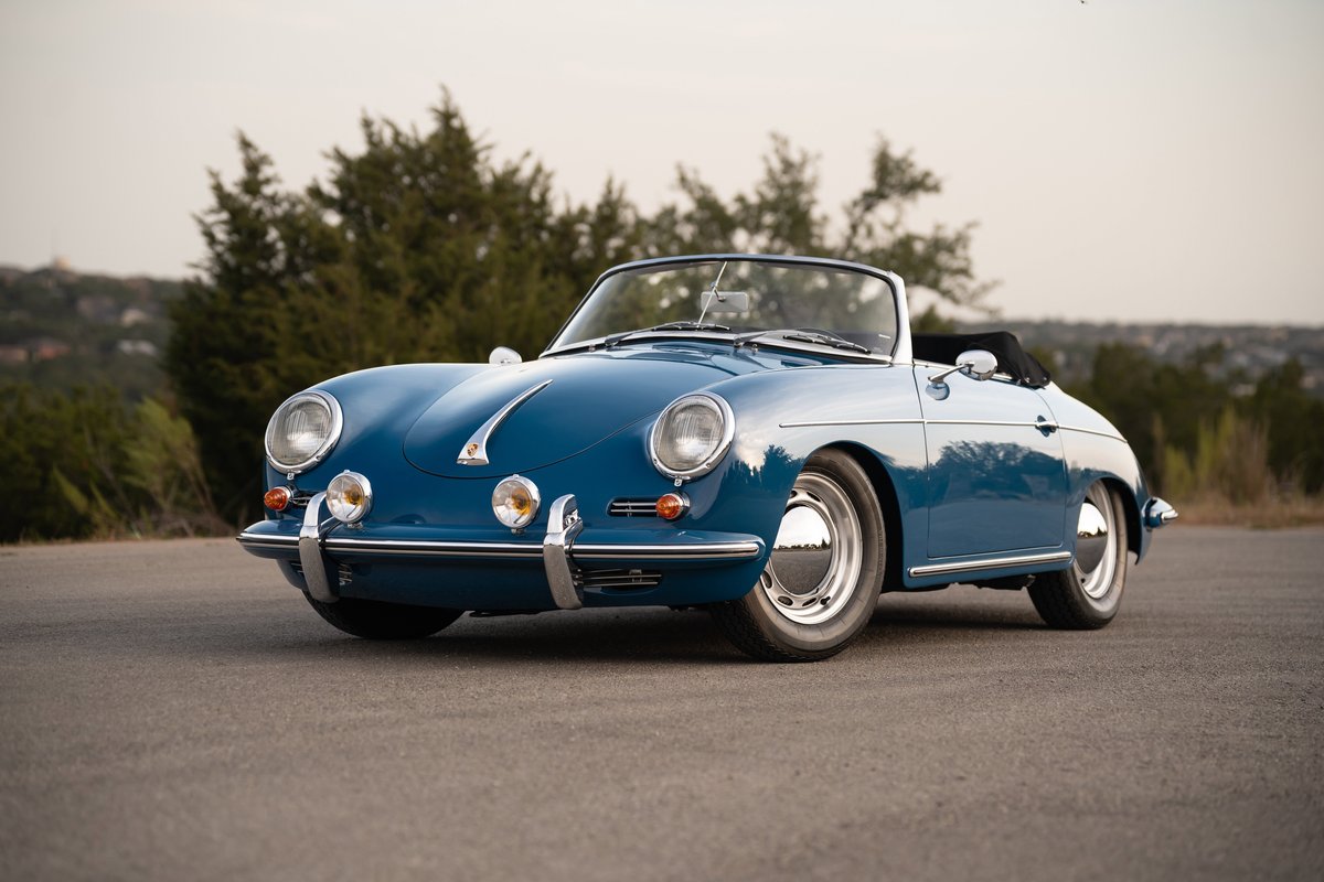 Blue 1960 Porsche 356B Roadster with chrome hubcaps on steel rims.